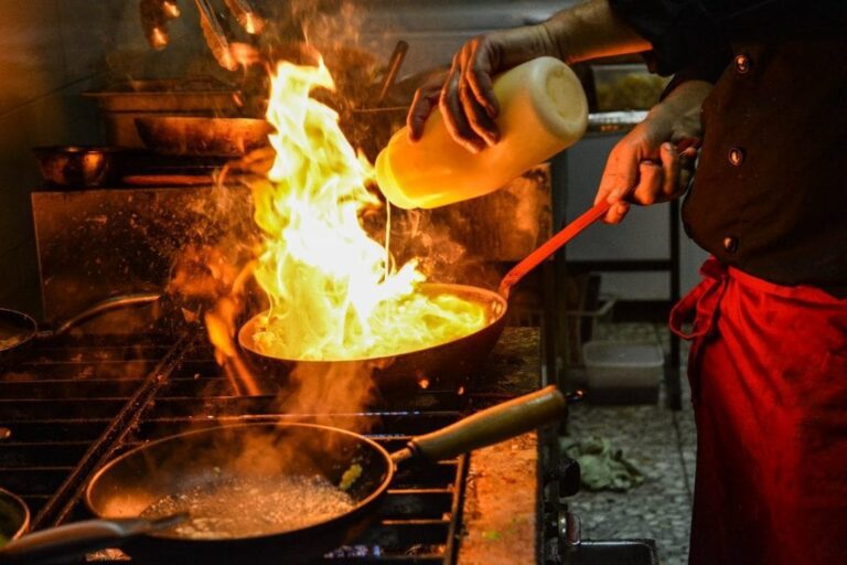 Chef pouring oil on pan
