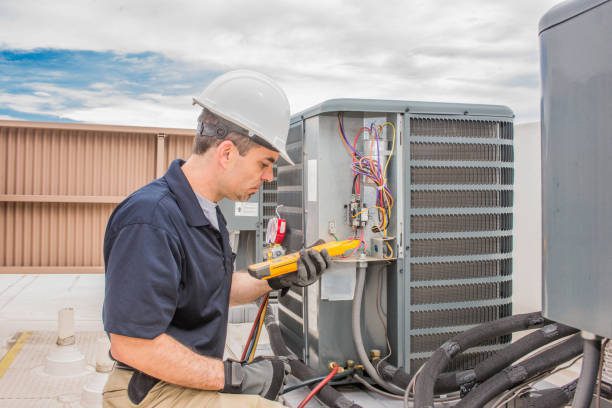 Man on roof installing air conditioning